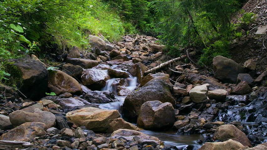 4K timelapse of stones in the mountain river, forest stream with stones time lapse, Stream Water and Rocks, mountain stream time lapse 4K, Granite boulders with river, track mountain stream