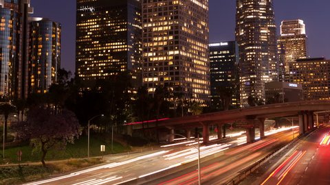 LOS ANGELES, CA, USA - APR17, 2015: 4K Time lapse zoom out rush hour traffic downtown Los Angeles skyline at sunset and twilight