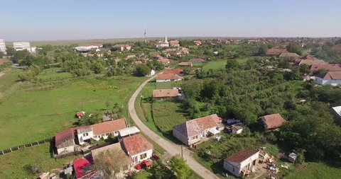 Aerial village in Romania with landmark, church and school