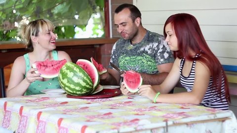 family lunch,eating watermelon family