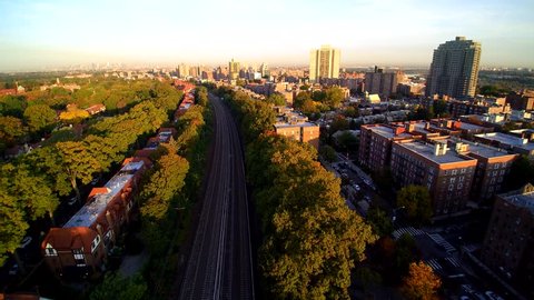 Queens NY train speeds to Manhattan morning 4k AERIAL