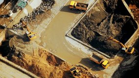 Excavators and tipper tracks working at construction. Hong Kong. Video form aerial view point