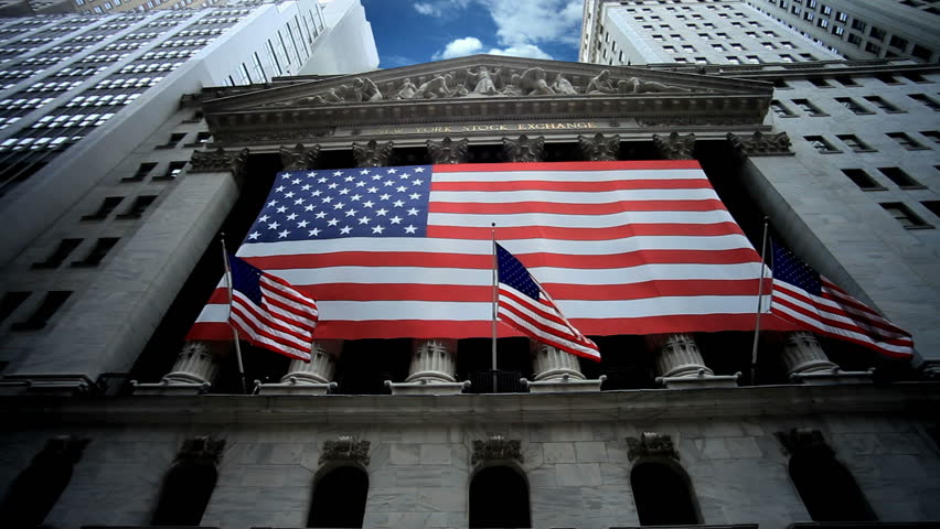 New York Stock Exchange - Beautiful Timelapse of NYSE in Lower Manhattan NYC USA with American Flags Waving and Blue Sky Overhead