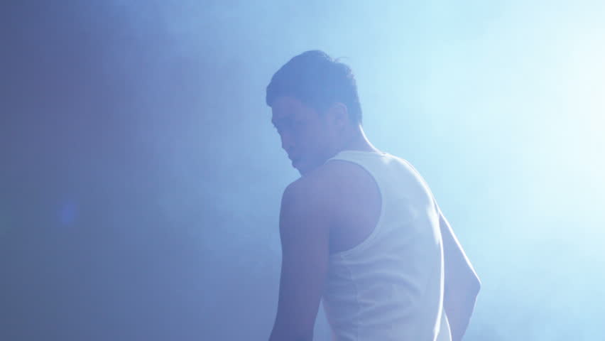 4K Young Asian martial artist training alone, practising his moves in urban industrial building. Shot on RED Epic.