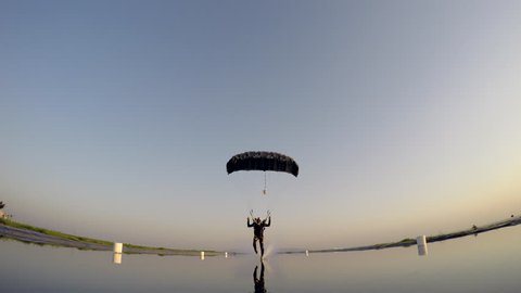 Skydiver fast landing on water, extreme sports
