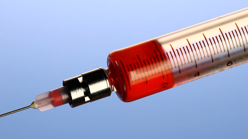 Macro shot of blood going into syringe