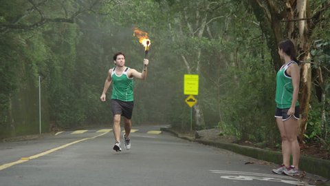 Slow motion olympic torch runners