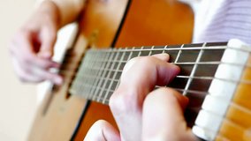 A young woman plays classical compositions on acoustic guitar in close up, Playing On An Acoustic Guitar, Slow Motion Video clip