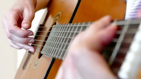 A young woman plays classical compositions on acoustic guitar in close up, Playing On An Acoustic Guitar, Slow Motion Video clip
