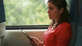Woman using a tablet inside a moving train