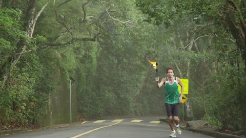 Slow motion olympic torch runnerの動画素材