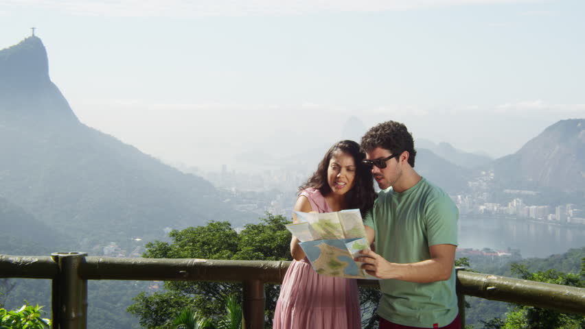 Young multiracial couple using a map