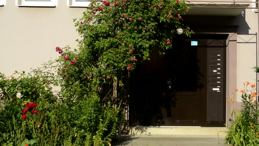 CZECH REPUBLIC, PRAGUE - JULY 8, 2015: detail of decorated entrance by flowers - urban style