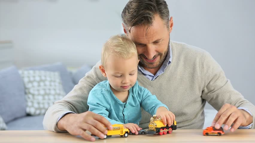 Daddy with baby playing with toy cars
