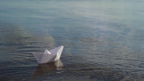 Paper boat floating on the river