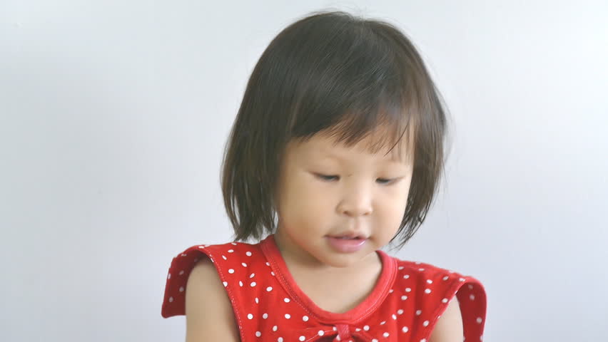 Little cute girl scratching her Head