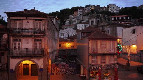 Dusk shot of a hillside in Porto with a caf\x8E and graffiti. Porto, Portugal - July, 2015