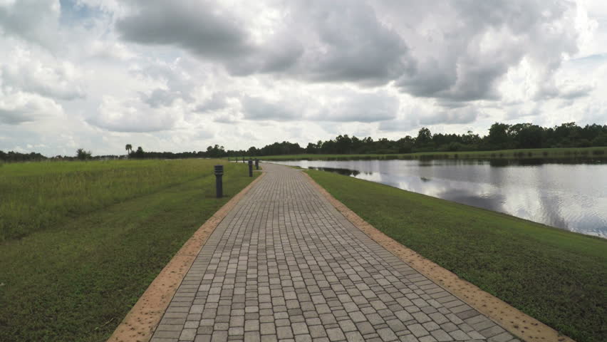 Walkway Next to Pond with Clouds