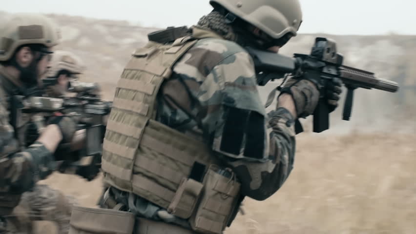 Slow motion of armed soldiers running forward to attack 