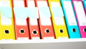 Colorful binders in the office. Colorful, vivid office background. Shallow DOF.