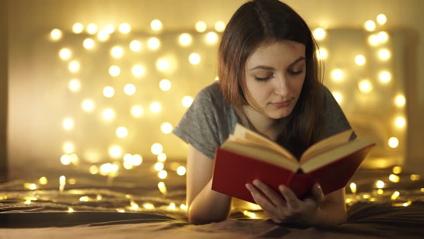 Vintage portrait of cute curly school girl reading a book in cold day