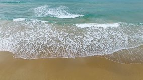 Aerial footage of Tropical Sandy beach with waves breaking on shore