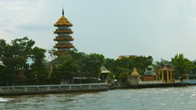 Cruising past Zhi Zhen Ge Temple from aboard a small boat on the Chao Phraya River in Bangkok. Thailand. Video FullHD