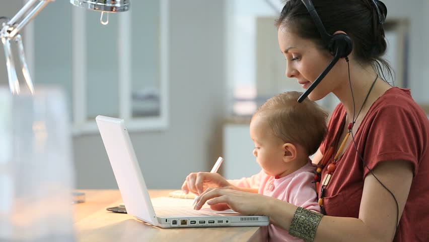 Busy businesswoman working with baby on lap Royalty-Free Stock Footage #12507446