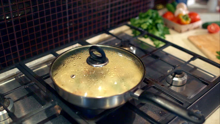 Cooking omelette with vegetables and mushrooms on the stove