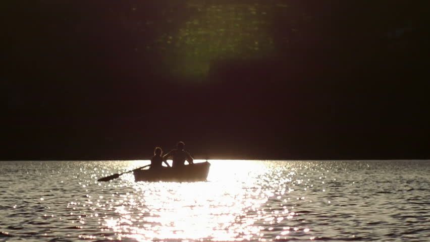 romantic couple on boat, at lake sunset
