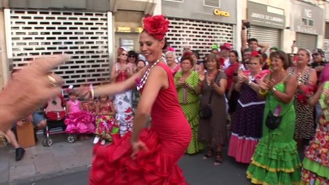 MALAGA, SPAIN - AUGUST, 14: People dancing in flamenco style dress and getting fun at the Malaga August Fair, on August, 14, 2014 in Malaga, Spain