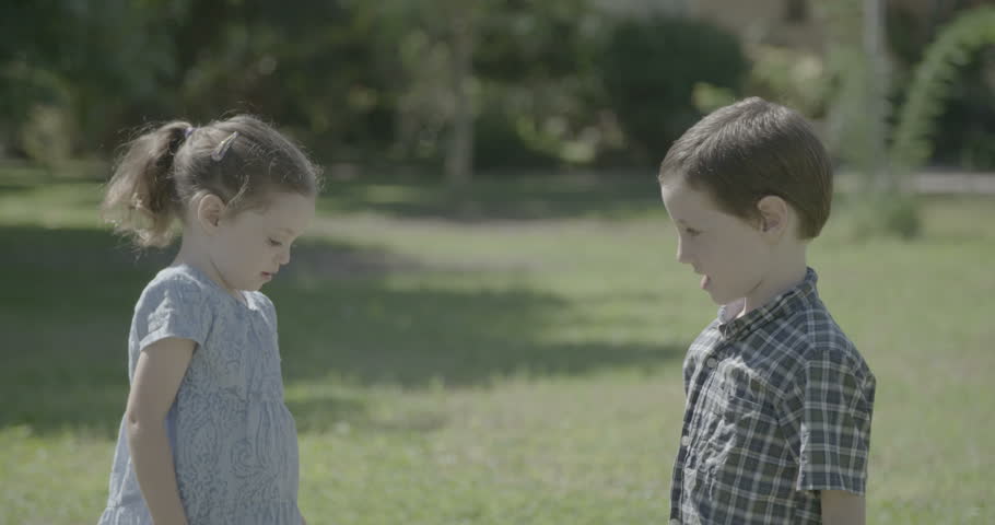 A boy and a little girl hugging and kissing