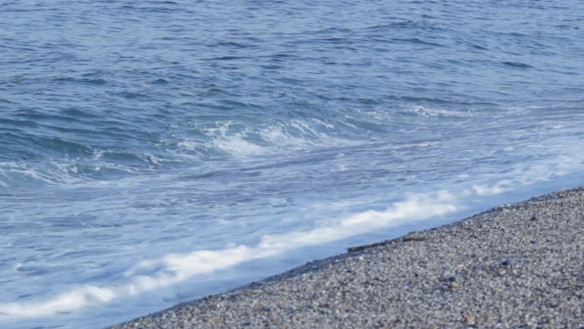 Waves breaking on a shingle beach in South Devon, UK