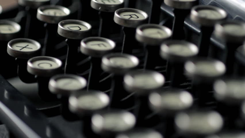 Rack focus across keys of old-fashioned typewriter