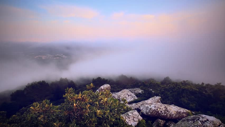 Cinemagraph Loop - Clouds move quickly over rock and forest - motion photo