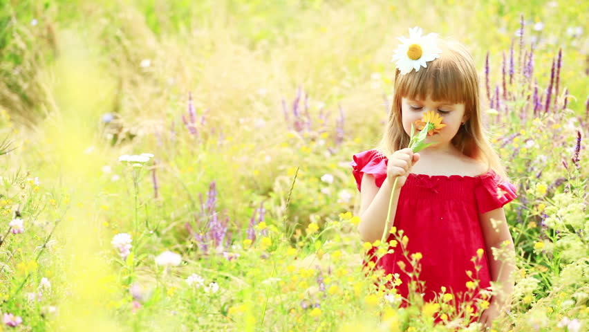 Girl smelling a yellow flower 