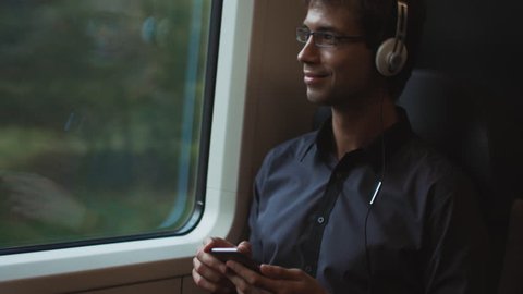 Man Listening to Music During Traveling. Shot on RED Cinema Camera in 4K (UHD).