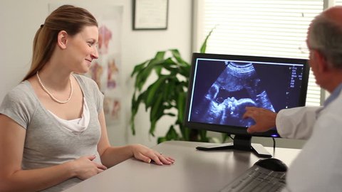 A doctor showing mother her ultrasound