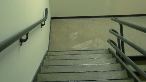 POV view of walking down the emergency stairs in an office highrise building