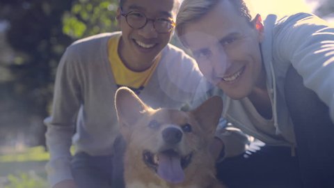 Interracial Gay Couple Take A Selfie With Their Cute Corgi Dog, In The Park
