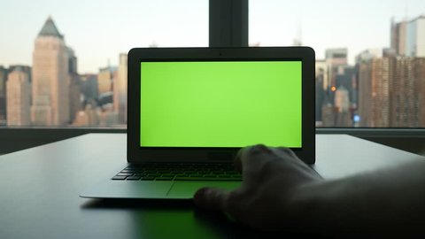laptop with isolated green screen. urban city background. modern computer technology. tracking dolly shot  Video de stock