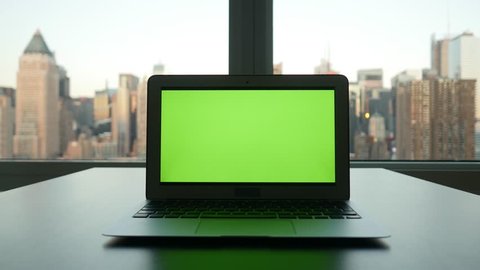 laptop with isolated green screen. urban city background. modern computer technology. tracking dolly shot  Stock Video