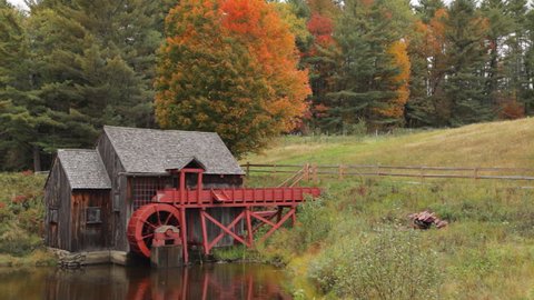 Pan of an old grist mill near Guildhall, Vermont with brilliant Fall foliage in the background. Stock-video