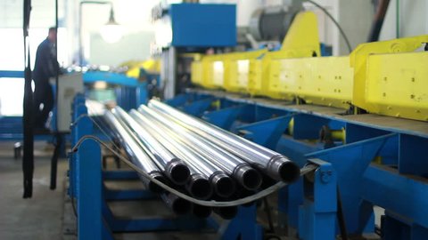 Workflow at the factory/Steel pipes production line/Production process at manufacturing plant/Manufacturing line of stainless steel pipes/Industrial equipment at factory/Heavy industry