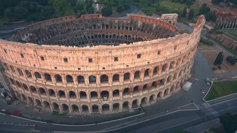 Colosseum, Rome, Italy. Aerial  Roman Coliseum on sunrise. Beautiful view of the famous Italian landmark travel icon in the Roman forum.
