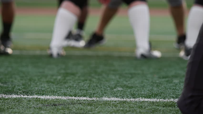 Close up of a football player kicking the ball toward the goal posts Royalty-Free Stock Footage #12561956