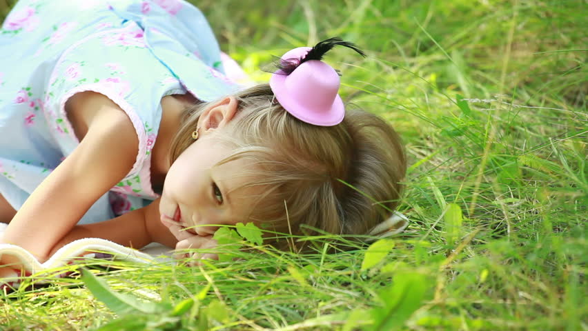 Little girl lying in grass 