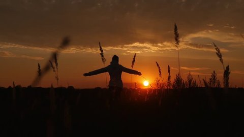 Happy joyful girl running away to the horizon to meet the sunset. Slow motion dolly shot