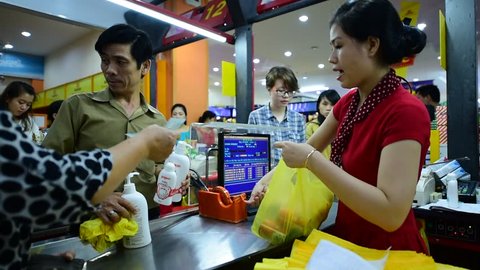 NHA TRANG, VIETNAM - OCTOBER 7, 2015: An unidentified cashier of a Maximark supermarket works at her counter. 