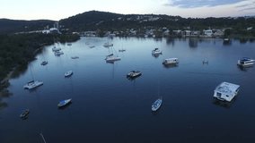Aerial footage views of Queensland Tourism hot spot Noosa Heads and Noosa River, with clean blue pristine tropical water. Featuring boats, moorings, wetlands, sandbars, tourists and holiday makers.